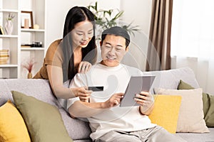Happy Couple Shopping Online with Credit Card at Home