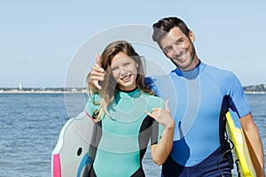 happy couple showing surf signs