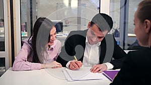 Happy couple signing real-estate contract