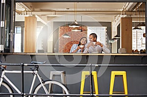 Happy couple sitting at a coffee shop on a fun date at a cafe or restaurant with peace. Woman and man at a table relax