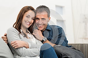 Happy Couple Sitting On Couch