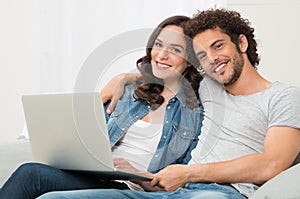 Happy Couple Sitting On Couch