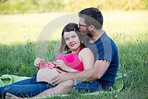 Happy couple sitting in grass