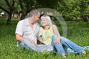 Happy couple sitting on the grass