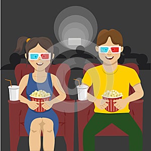 Happy couple sitting in movie theater, watching 3D movie, eating popcorn, smiling