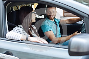 Happy couple sitting in their new car