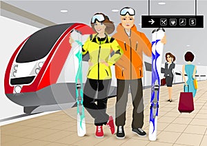 Happy couple skiers standing at the train station