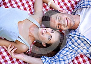 Happy, couple and smile on blanket for picnic in portrait for bonding, connection and date. Man, woman and face with