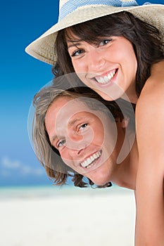 Happy couple smiling on the beach