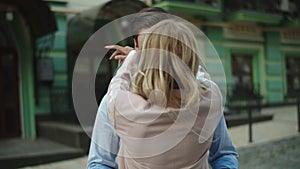 Happy couple standing together at street. Couple hugging each other outdoors