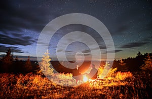 Happy couple staring at starry sky