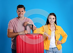 Happy couple with suitcase for summer trip on background. Vacation travel