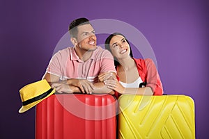 Happy couple with suitcases for summer trip on background. Vacation travel