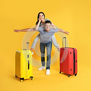 Happy couple with suitcases for summer trip on background. Vacation travel