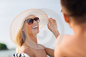 Happy couple sunbathing on summer beach