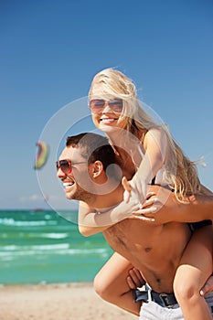 happy couple in sunglasses on the beach