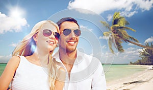 Happy couple in sunglasses at maldives beach