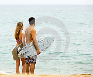 Happy couple with surf boards