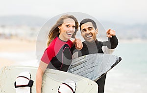 Happy couple with surf boards