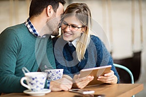 Happy couple surfing on tablet