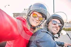 Happy couple taking selfie on moped