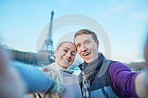 Happy couple taking selfie in Paris