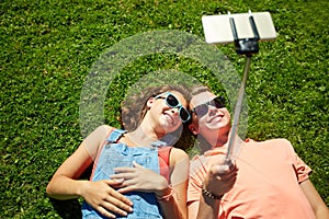 Happy couple taking selfie on smartphone at summer