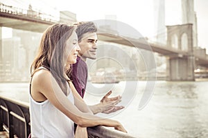 Happy couple talking in front the famous Brooklyn bridge