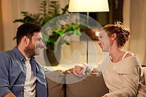 Happy couple talking at home in evening