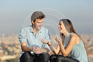 Happy couple talking in a sunny day in a city outskirts photo