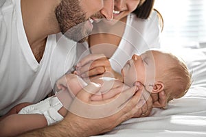 Happy couple with their newborn baby at home