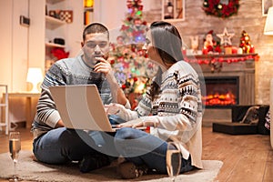 Happy couple thinking about the gifts they have to buy