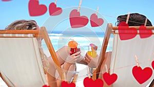 Happy couple toasting on beach