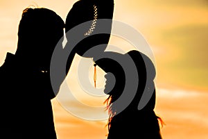 Happy couple together at sunset silhouette of natur photo