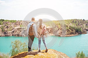 Happy couple at top of mountain enjoy the view of blue lake