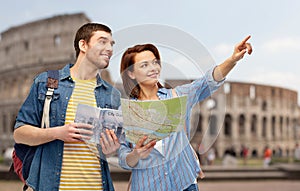 Happy couple of tourists with city guide and map