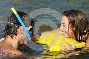 Happy couple of tourists joking bathing on the beach