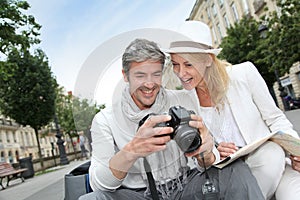 Happy couple of tourists taking photos photo