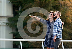 Happy couple of tourists walking in city, copy space