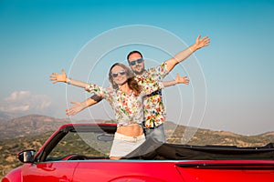 Happy couple travel by car in the mountains