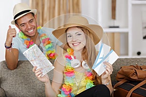 happy couple travelers with passports and tickets