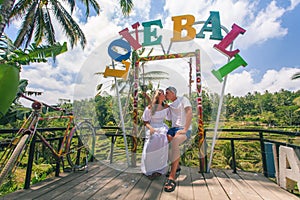 Happy couple traveling at Bali, rice terraces of Tegalalang, Ubud