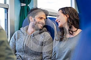 Happy couple traveling by train