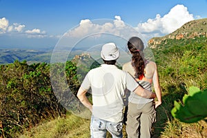 Happy couple trekking in mountains, hiking tourists