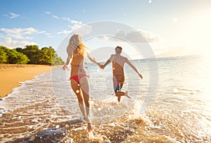 Happy Couple on Tropical Beach at Sunset