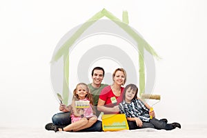 Happy couple with two kids repainting their home