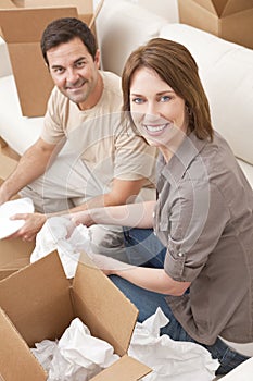 Happy Couple Unpacking Packing Boxes Moving House