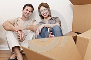 Happy Couple Unpacking Packing Boxes Moving House