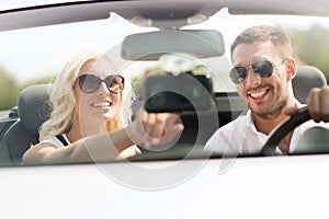 Happy couple usin gps navigation system in car