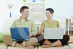 Happy couple using computer
